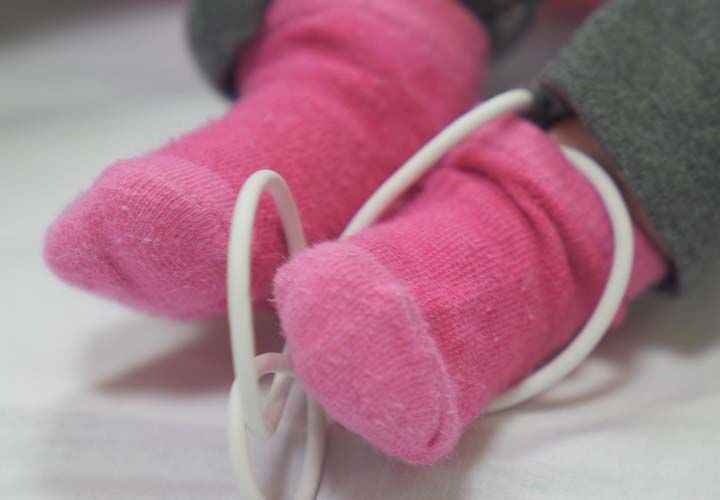 baby wearing pink socks