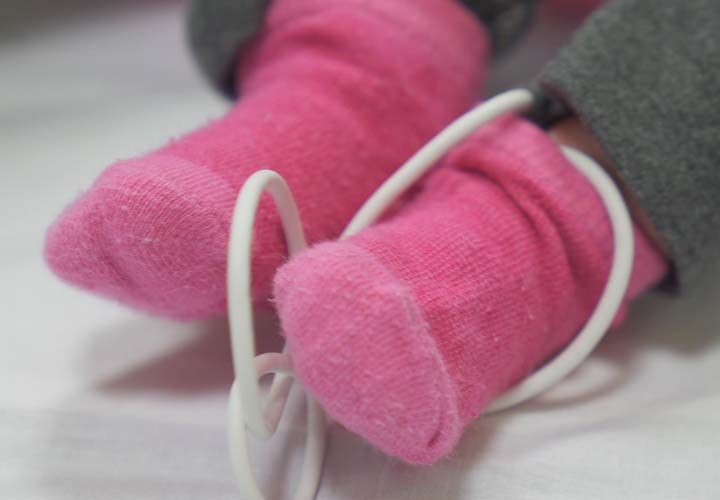 a babys feet with pink socks