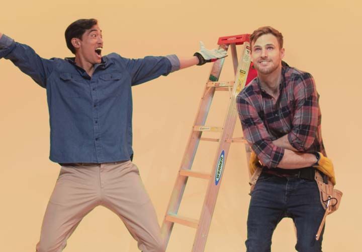 two smiling men doing home repairs in front of a yellow background