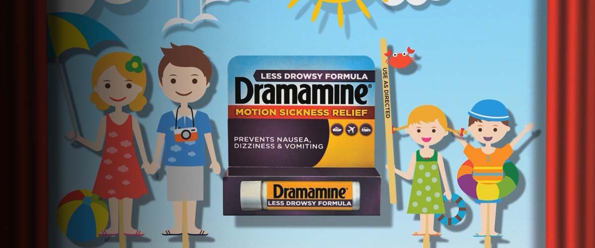 a cartoon family smiling and waving standing next to an oversized package of Dramamine Motion Sickness medicine
