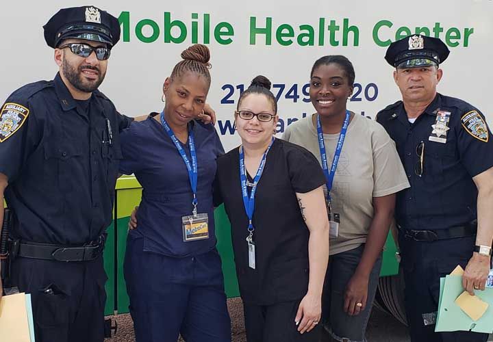 a group of Ryan Health staff and police offeres posing for a photo