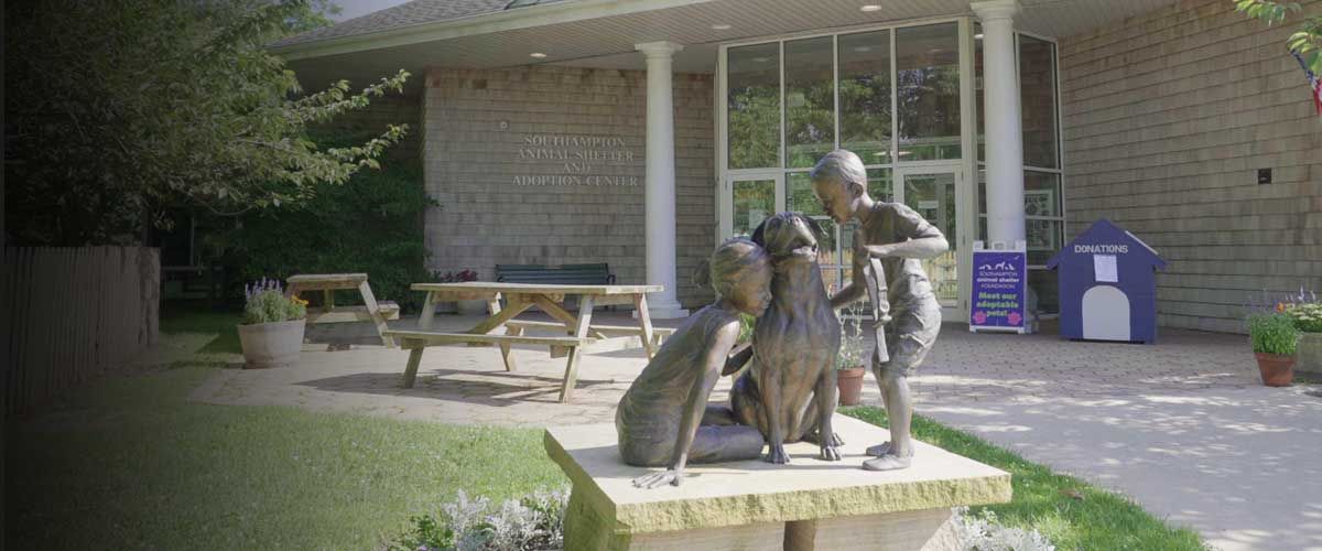 statue of a dog surrounded by children outside of the Southampton Animal Shelter