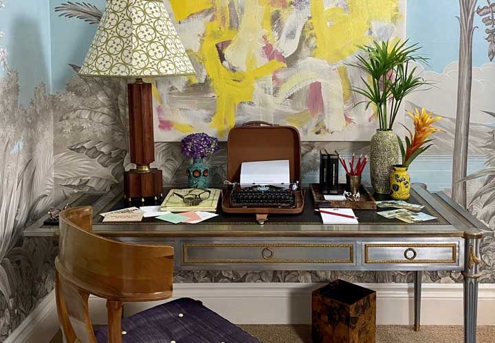 a styled desk with stylish wallpaper